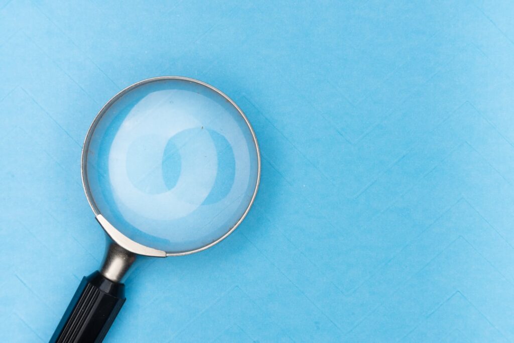 Magnifying glass comparing insurance options