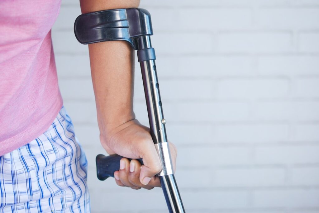 Person holding crutches, recovering from injury