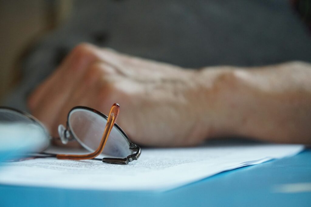 Glasses on table, reviewing paperwork