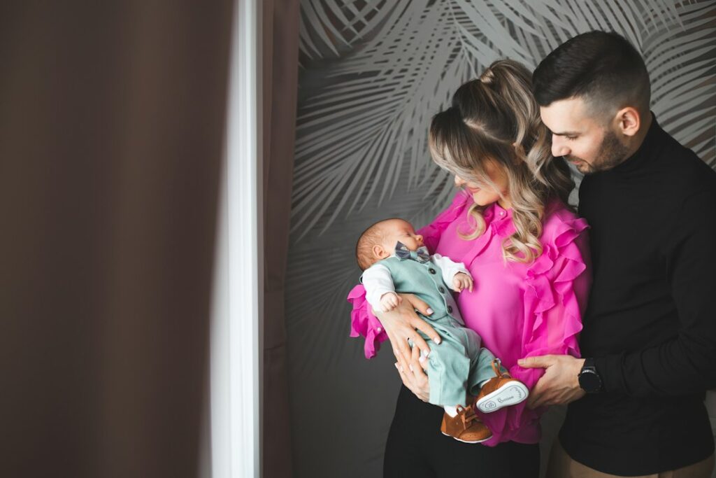 New parents holding their newborn baby at home
