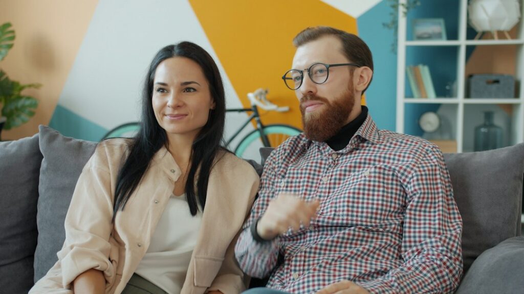 Young married couple laughing together at home