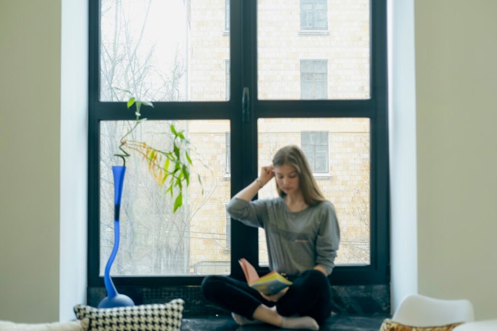 Single person relaxing at home by the window