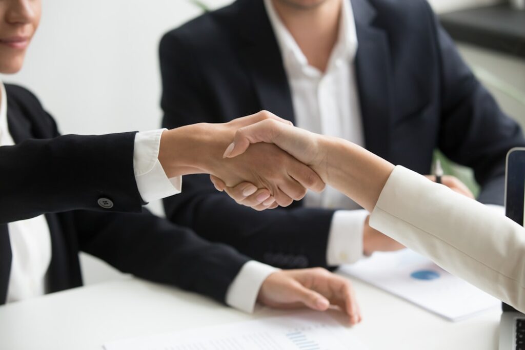 Business handshake representing local agent support